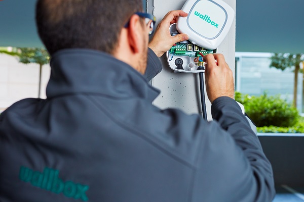certified installer installing an ev charging station in a condo - wallbox