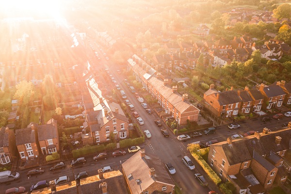 birds eye view of a british town with homes and cars